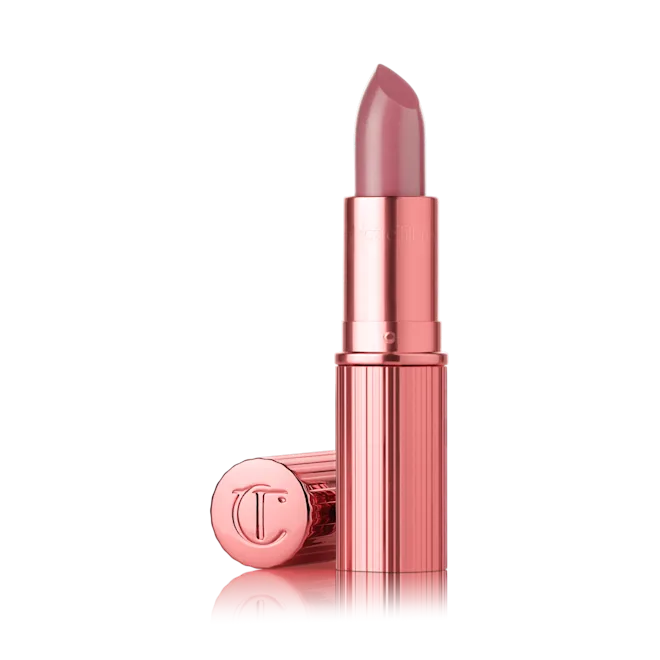 Charlotte Tilbury Icon Baby lipstick in a glossy nude-pink shade.