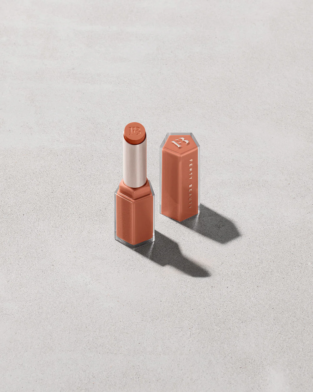 Fenty Gloss Bomb Stix High-Shine Gloss Stick delivers a non-sticky, juicy shine in warm-toned shades, perfect for warm olive beauties.